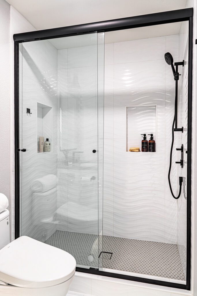 Tile Flooring Buying Guide inspiration. Large tile shower with glass door and niche