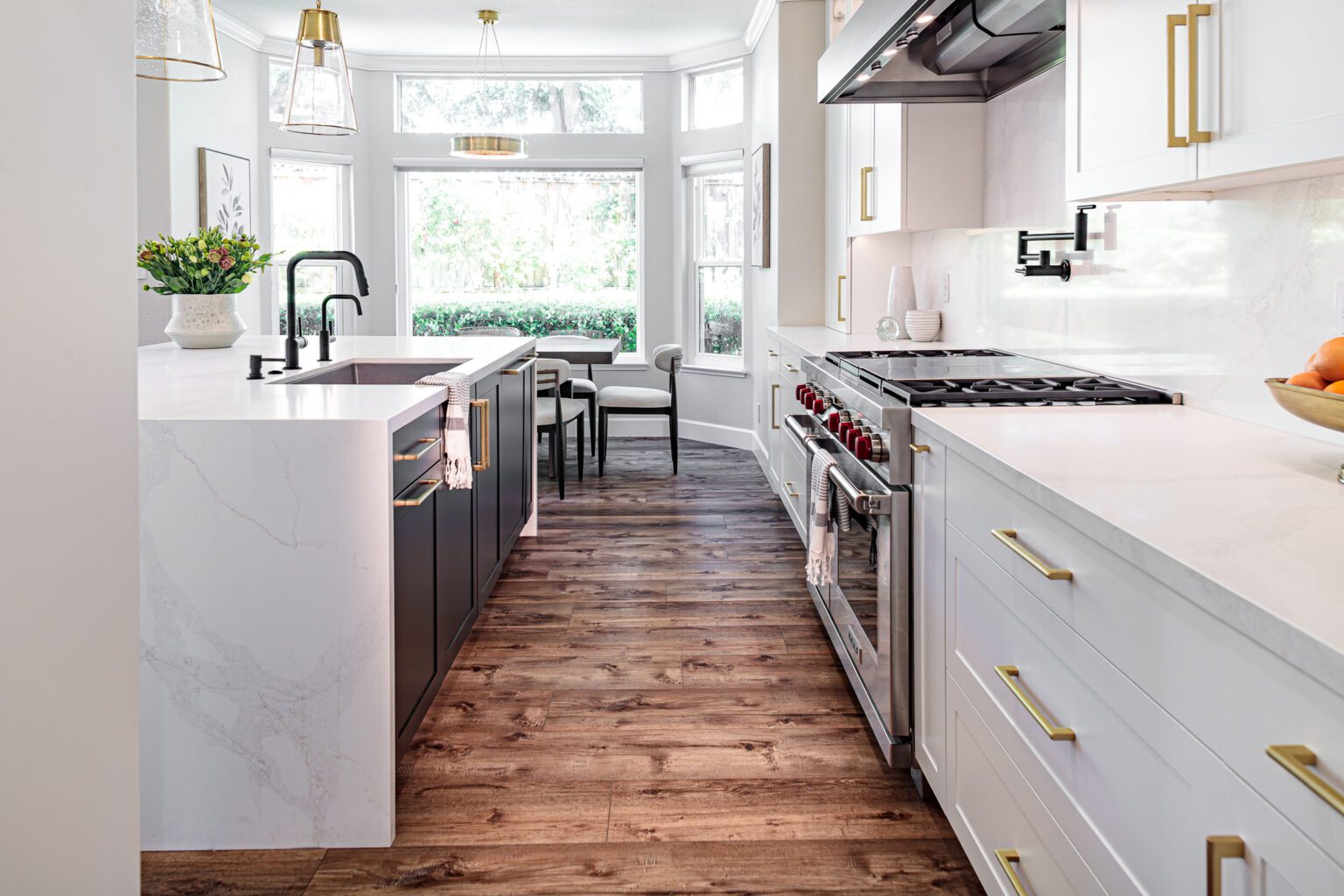 How a Kitchen Remodel Can Increase Your Home’s Value inspiration. Kitchen remodel with waterfall countertop and professional range