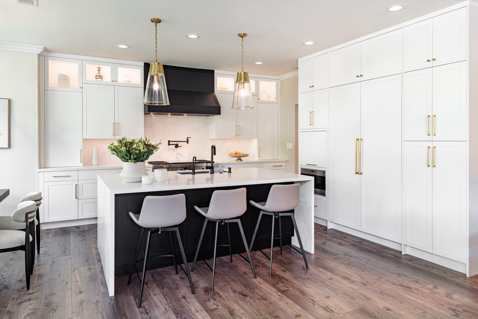 Custom Cabinet Ideas for Modern Homes inspiration. Large pantry cabinets and black and white kitchen island